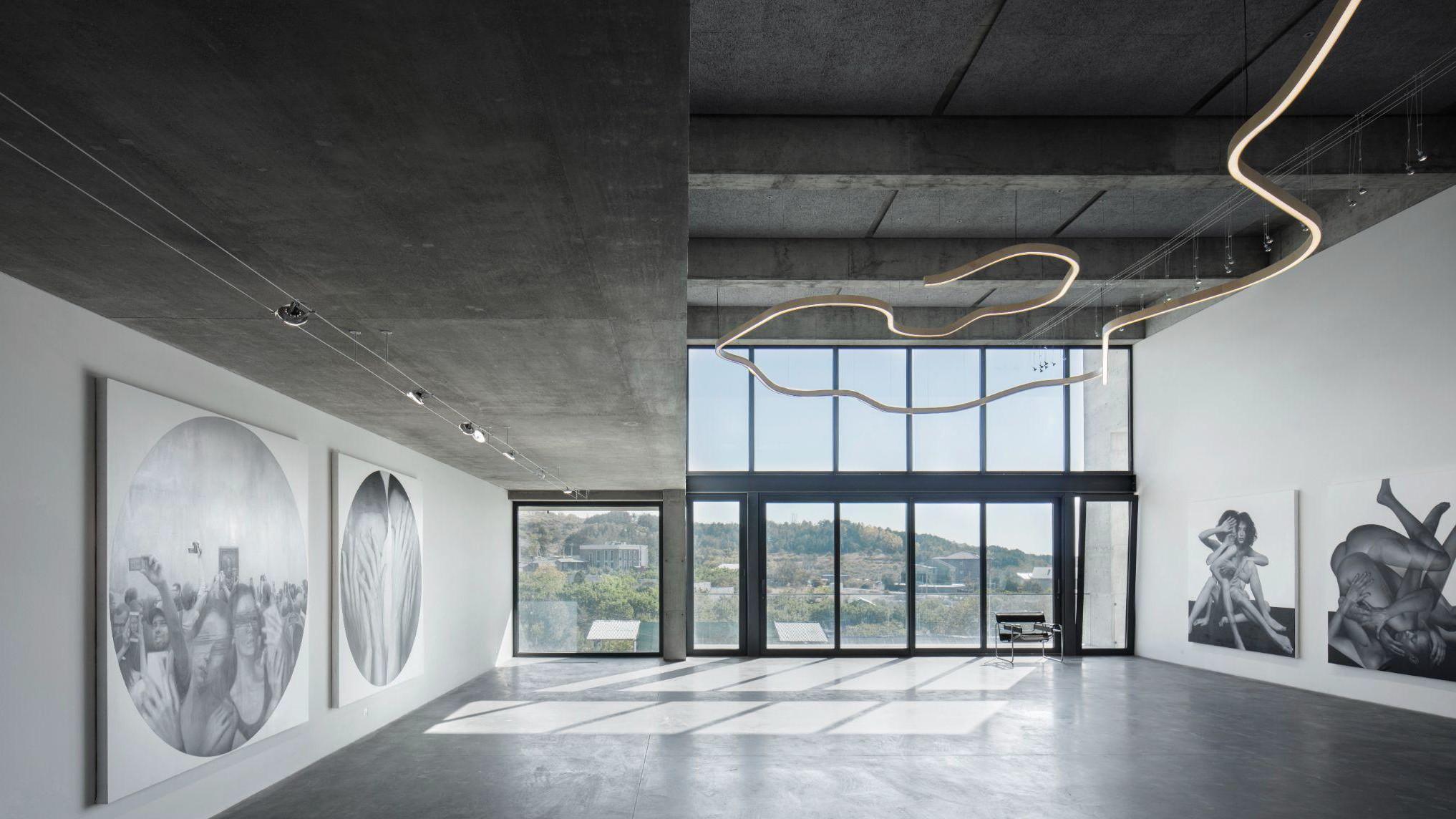 Exhibition space with concrete ceiling and large windows